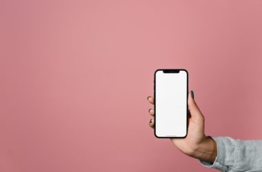 a person holding an iPhone with white screen