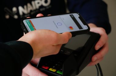 a person using Apple Pay at a store