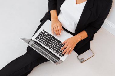 a woman in black blazer using a MacBook Pro